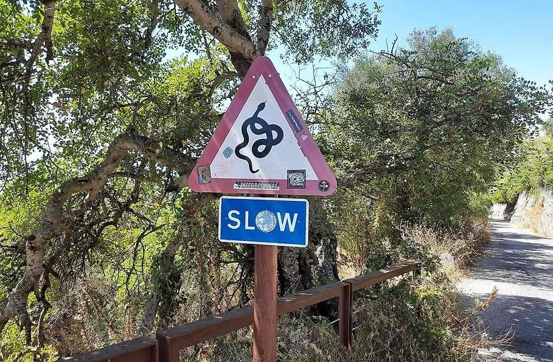 TOP Rock park v Gibraltaru a neobvyklá výstražná značky Hadi s dodatkovou cedulí Slow - zpomal.