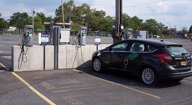 Vyhrazené místo u nabíjecí stanice slouží primárně pro aktivní doplňování energie. Samotné zaparkování bez nabíjení nebo dlouhé stání po dobití může být problém podle značení i ceníku provozovatele., zdroj: Fortunate4now /Wikimedia CC0